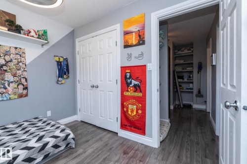 Bedroom with a closet and dark wood-type flooring - 4371 46 Street, Stony Plain, AB - Indoor Photo Showing Bedroom