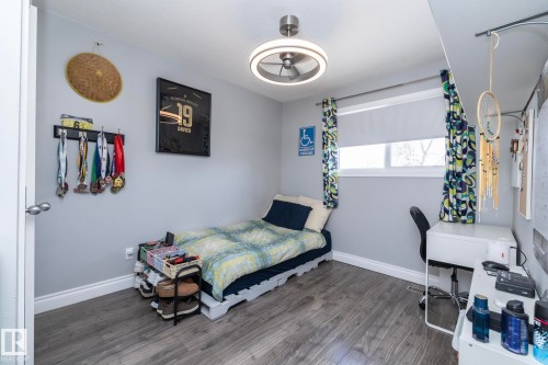 Bedroom with wood finished floors and baseboards - 4371 46 Street, Stony Plain, AB - Indoor Photo Showing Bedroom
