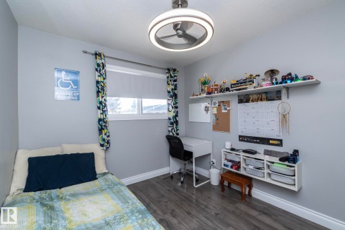 Bedroom featuring baseboards and dark wood-type flooring - 4371 46 Street, Stony Plain, AB - Indoor Photo Showing Bedroom