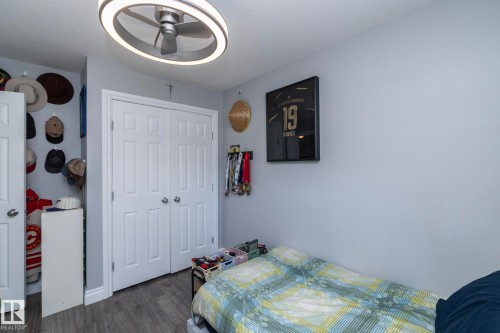 Bedroom featuring wood finished floors, a closet, a textured ceiling, and ceiling fan - 4371 46 Street, Stony Plain, AB - Indoor Photo Showing Bedroom