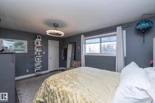 Bedroom featuring baseboards and a ceiling fan - 4371 46 Street, Stony Plain, AB - Indoor Photo Showing Bedroom