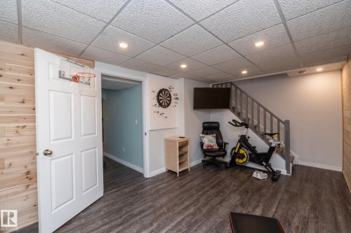 Finished below grade area featuring a paneled ceiling, dark wood-style flooring, and recessed lighting - 4371 46 Street, Stony Plain, AB - Indoor Photo Showing Other Room