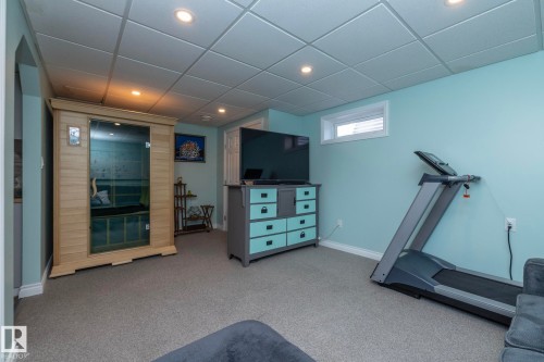 Workout area with a relaxing sauna, light carpet, recessed lighting, and a paneled ceiling - 4371 46 Street, Stony Plain, AB - Indoor Photo Showing Gym Room
