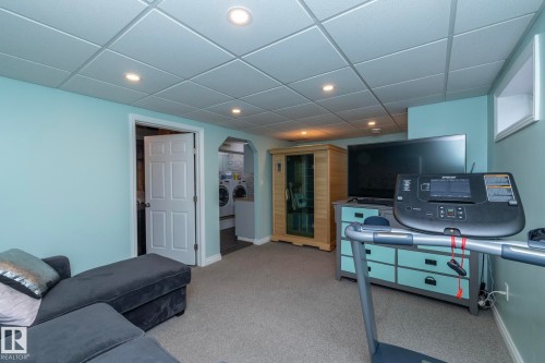 Living room featuring a sauna, recessed lighting, light colored carpet, a drop ceiling, and washer and clothes dryer - 4371 46 Street, Stony Plain, AB - Indoor