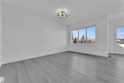 Unfurnished dining area with baseboards and light wood-style floors - 1822 Collip View View, Edmonton, AB - Indoor Photo Showing Other Room