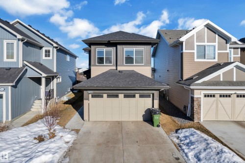View of front facade with a shingled roof, driveway, a residential view, and an attached garage - 1822 Collip View View, Edmonton, AB - Outdoor