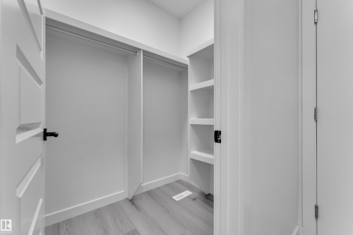 Walk in closet with light wood-type flooring - 1822 Collip View View, Edmonton, AB - Indoor Photo Showing Other Room