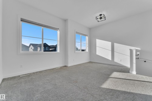 Carpeted spare room featuring baseboards - 1822 Collip View View, Edmonton, AB - Indoor Photo Showing Other Room