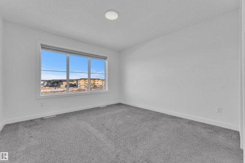 Empty room with baseboards and light carpet - 1822 Collip View View, Edmonton, AB - Indoor Photo Showing Other Room