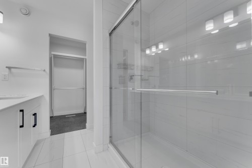 Full bath featuring vanity, a stall shower, and light tile patterned floors - 1822 Collip View View, Edmonton, AB - Indoor Photo Showing Bathroom