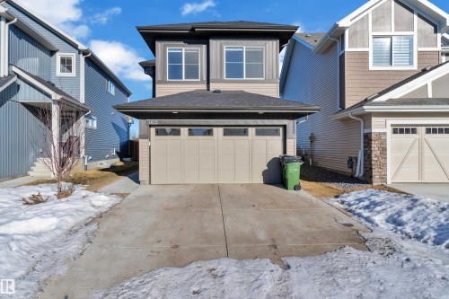 View of front facade featuring an attached garage, concrete driveway, and roof with shingles - 1822 Collip View View, Edmonton, AB - Outdoor