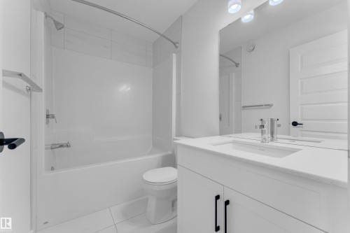 Bathroom featuring vanity, bathing tub / shower combination, and light tile patterned flooring - 1822 Collip View View, Edmonton, AB - Indoor Photo Showing Bathroom