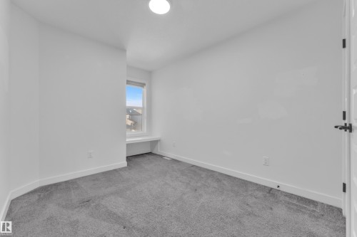 Unfurnished bedroom featuring light colored carpet and baseboards - 1822 Collip View View, Edmonton, AB - Indoor Photo Showing Other Room