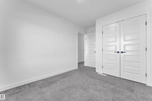 Unfurnished bedroom with carpet floors and a closet - 1822 Collip View View, Edmonton, AB - Indoor Photo Showing Other Room