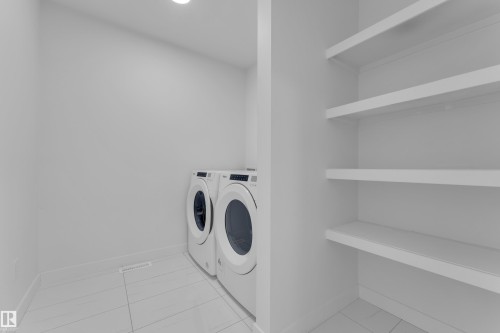 Laundry area with baseboards and independent washer and dryer - 1822 Collip View View, Edmonton, AB - Indoor Photo Showing Laundry Room