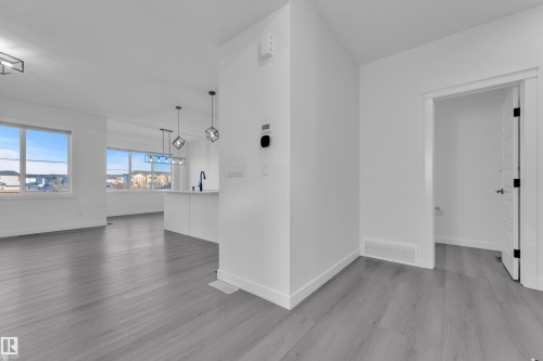 Spare room featuring baseboards and dark wood-style flooring - 1822 Collip View View, Edmonton, AB - Indoor Photo Showing Other Room