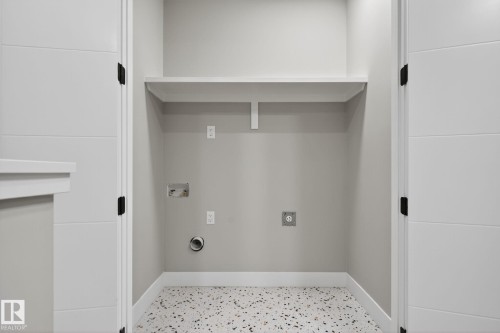 Laundry area with washer hookup and electric dryer hookup - 456 Crystal Creek Link, Leduc, AB - Indoor Photo Showing Other Room