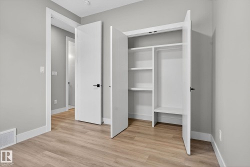 Unfurnished bedroom featuring light wood-type flooring and a closet - 456 Crystal Creek Link, Leduc, AB - Indoor Photo Showing Other Room