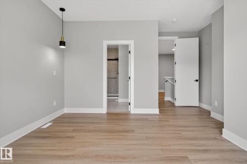 Spare room with light wood-style floors - 456 Crystal Creek Link, Leduc, AB - Indoor Photo Showing Other Room