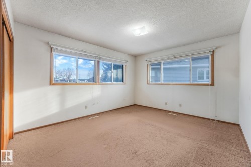 Unfurnished room with carpet and a textured ceiling - 10324 42 Street, Edmonton, AB - Indoor Photo Showing Other Room