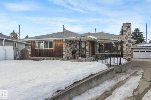 View of front facade featuring a shingled roof and stone siding - 10324 42 Street, Edmonton, AB - Outdoor