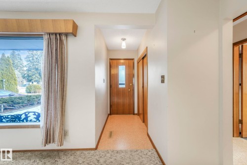 Hall with baseboards and dark speckled floor - 10324 42 Street, Edmonton, AB - Indoor Photo Showing Other Room