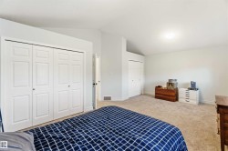 Bedroom with vaulted ceiling, two closets, and carpet - 