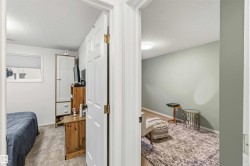 Bedroom with a textured ceiling and light colored carpet - 