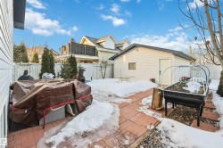 View of snow covered exterior featuring a fenced backyard, a balcony, and a patio - 