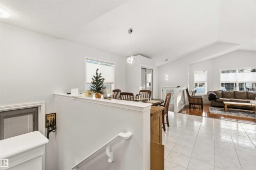 Dining space featuring lofted ceiling and light tile patterned floors - 1706 Turvey Bend, Edmonton, AB - Indoor