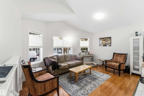 Living area featuring light wood-style flooring and lofted ceiling - 1706 Turvey Bend, Edmonton, AB - Indoor Photo Showing Living Room