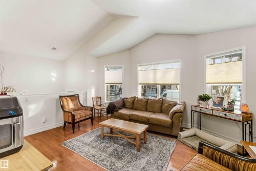 Living room featuring light wood-type flooring and healthy amount of natural light - 1706 Turvey Bend, Edmonton, AB - Indoor Photo Showing Living Room