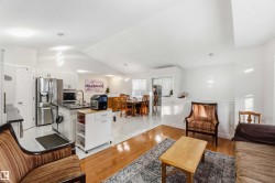 Living area with light wood finished floors and lofted ceiling - 