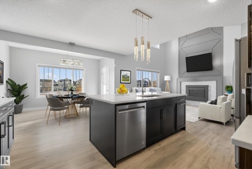 *VIRTUALLY STAGED - 1523 Darby Bay, Edmonton, AB - Indoor Photo Showing Kitchen With Fireplace With Upgraded Kitchen