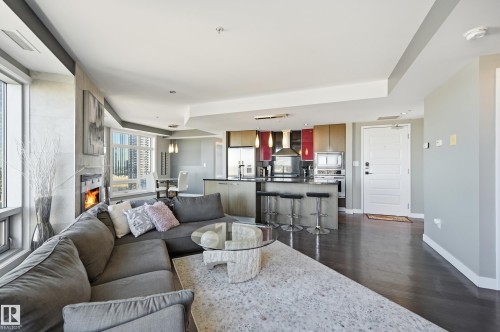 Living area with dark wood-style floors and baseboards - 2003 10388 105 Street, Edmonton, AB - Indoor Photo Showing Living Room