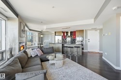 Living area with dark wood-style floors and baseboards - 