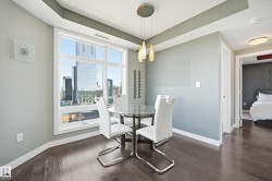 Dining area featuring dark wood-style flooring and a view of skyline - 