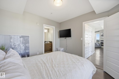 Bedroom with wood finished floors and ensuite bathroom - 2003 10388 105 Street, Edmonton, AB - Indoor Photo Showing Bedroom