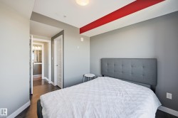 Bedroom featuring baseboards and dark wood-style flooring - 