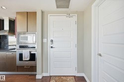 Kitchen featuring stainless steel appliances, dark wood-type flooring, and modern cabinets - 