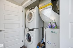 Laundry area with stacked washer and clothes dryer - 