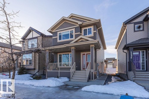 View of front of property featuring a porch and board and batten siding - 1224 Mcconachie Boulevard, Edmonton, AB - Outdoor With Deck Patio Veranda With Facade