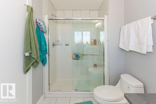 Full bath featuring a shower stall, vanity, and tile patterned flooring - 1224 Mcconachie Boulevard, Edmonton, AB - Indoor Photo Showing Bathroom