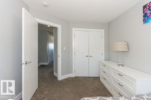 Bedroom with dark colored carpet and a closet - 1224 Mcconachie Boulevard, Edmonton, AB - Indoor