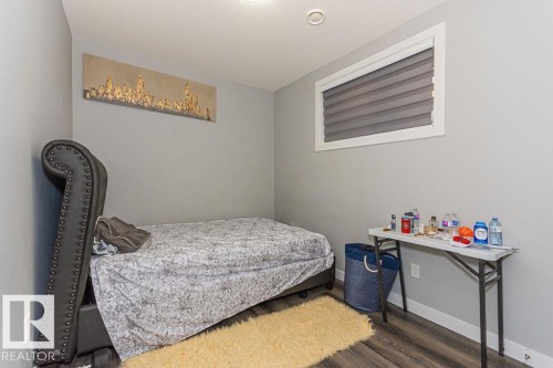 Bedroom featuring baseboards and dark wood-type flooring - 1224 Mcconachie Boulevard, Edmonton, AB - Indoor Photo Showing Bedroom
