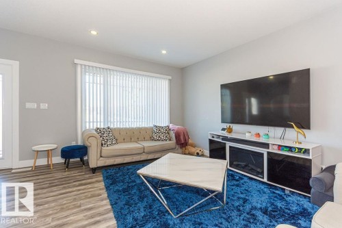 Living area featuring wood finished floors and recessed lighting - 1224 Mcconachie Boulevard, Edmonton, AB - Indoor Photo Showing Living Room