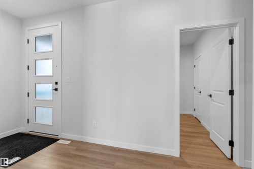 Entryway with baseboards and light wood-type flooring - 112 25 Street, Edmonton, AB - Indoor Photo Showing Other Room