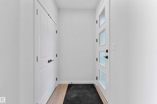 Hallway with light wood-style flooring and baseboards - 112 25 Street, Edmonton, AB - Indoor Photo Showing Other Room