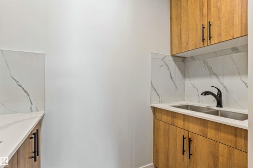 Laundry room featuring a sink - 112 25 Street, Edmonton, AB - Indoor Photo Showing Kitchen With Double Sink