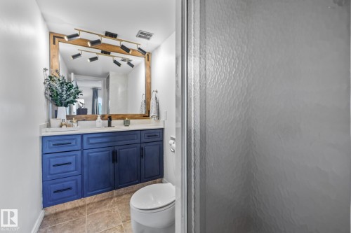 Bathroom featuring vanity, an enclosed shower, and light tile patterned floors - 1502 9909 110 Street, Edmonton, AB - Indoor Photo Showing Bathroom